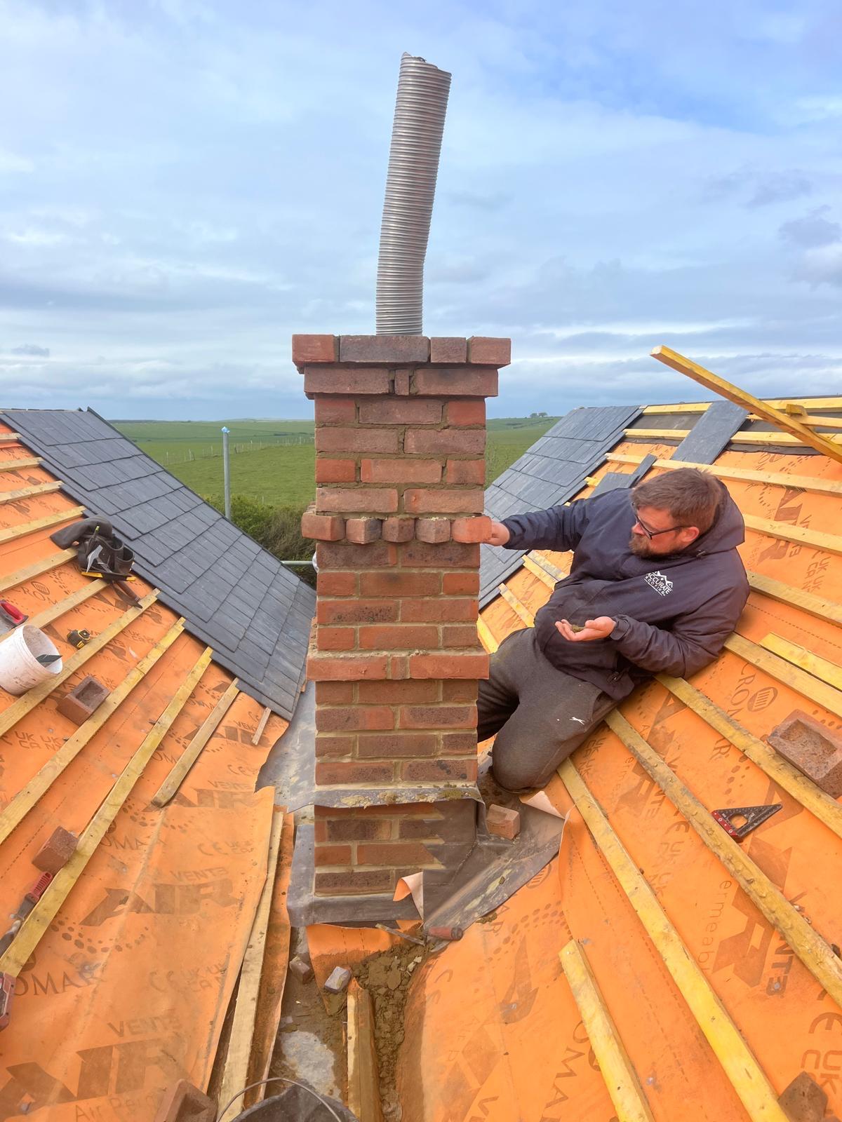 Chimney repair work in progress on a roof in East Sussex
