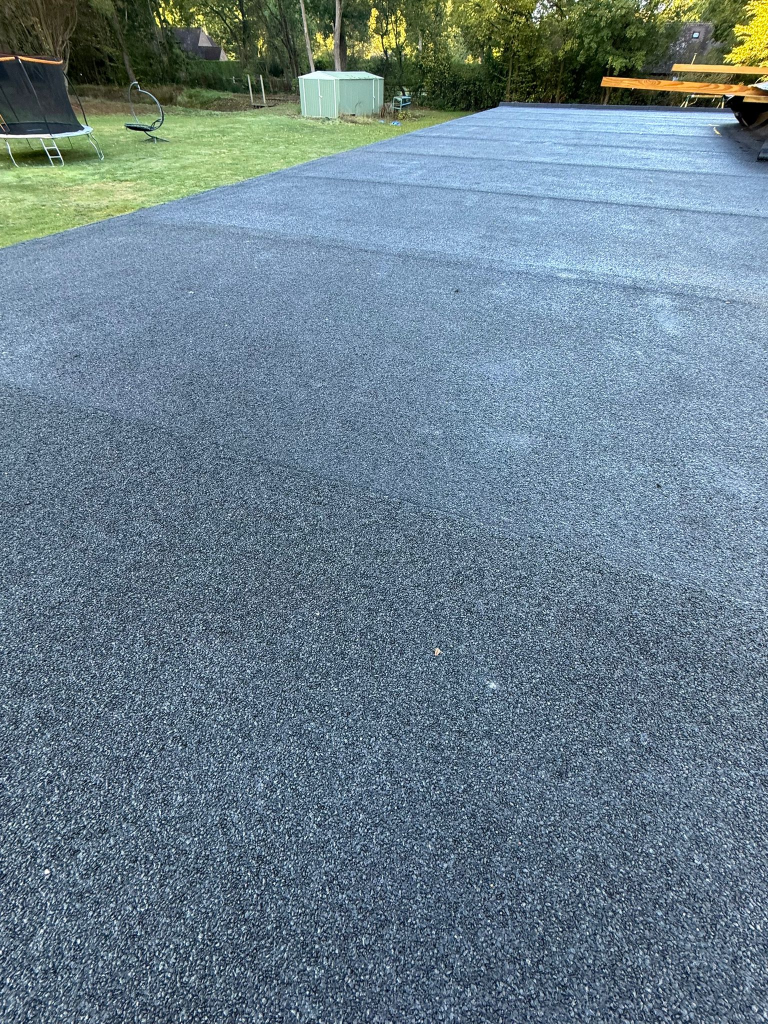 Flat roof installation featuring premium EPDM system, showcasing clean, textured surface in a residential setting.